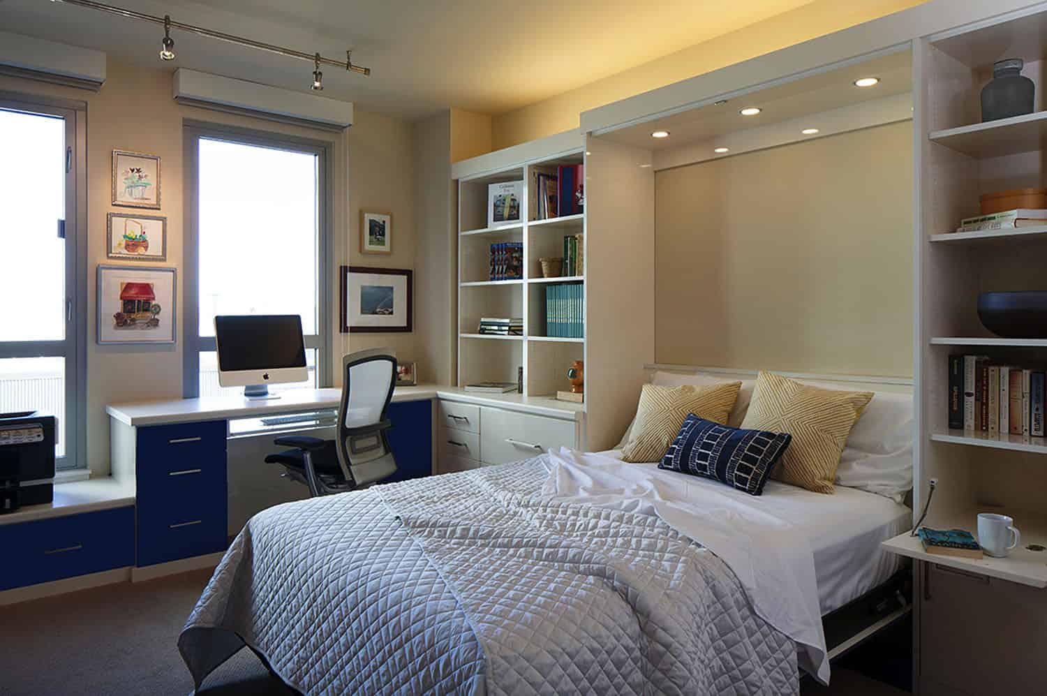 Guest bedroom in a private home set up for short-term rental with a laptop on a desk
